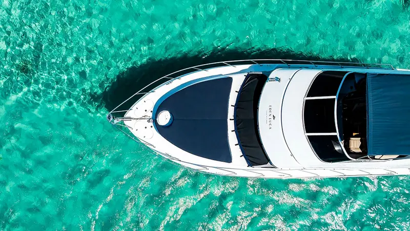 The navy bow lounge of Eden Luca Blue seen from above over clear turquoise water