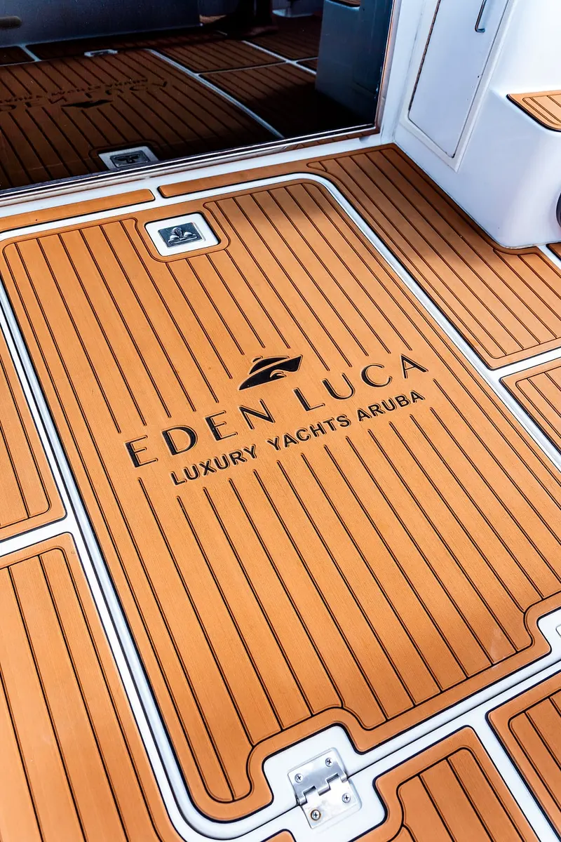 Eden Luca Luxury Yachts Aruba logo set into the teak aft deck of Eden Luca Blue