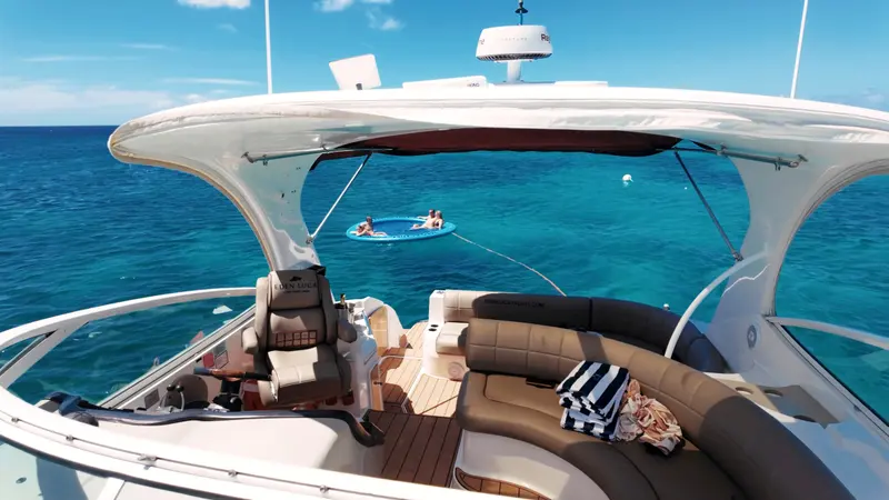Cockpit lounge of Eden Luca Red at anchor, guests relaxing on the SunChill float behind