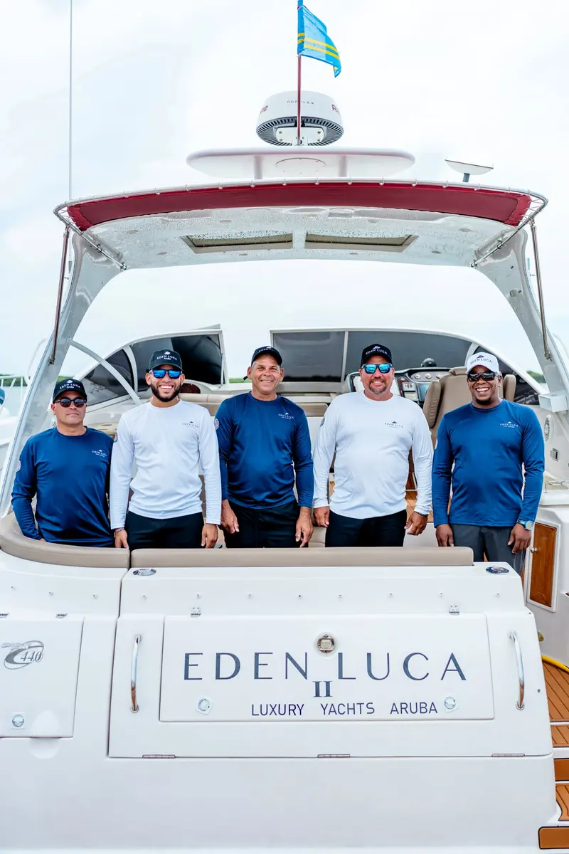 Meet your crew: five Eden Luca crew members in uniform on the stern of Eden Luca Red