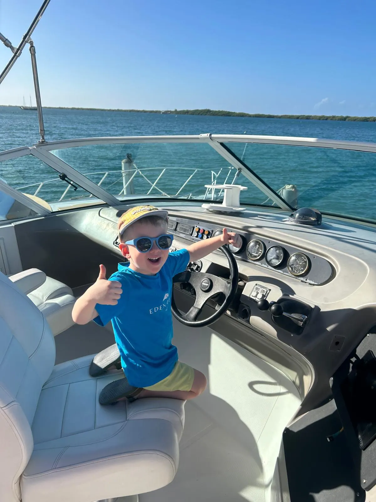 Eden Luca, the boy our flagship yacht is named after, at the helm of Eden Luca Blue in Aruba