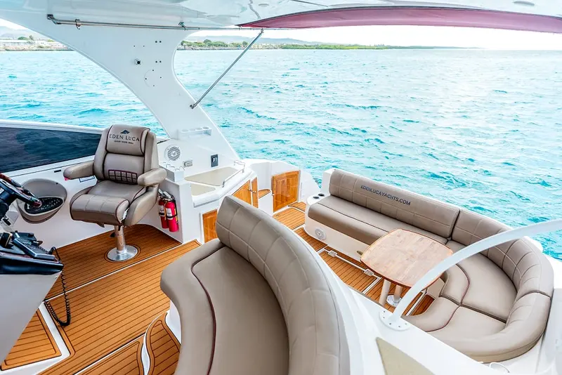Helm seat and wraparound cockpit lounge of Eden Luca Red under the hardtop, sea views all around