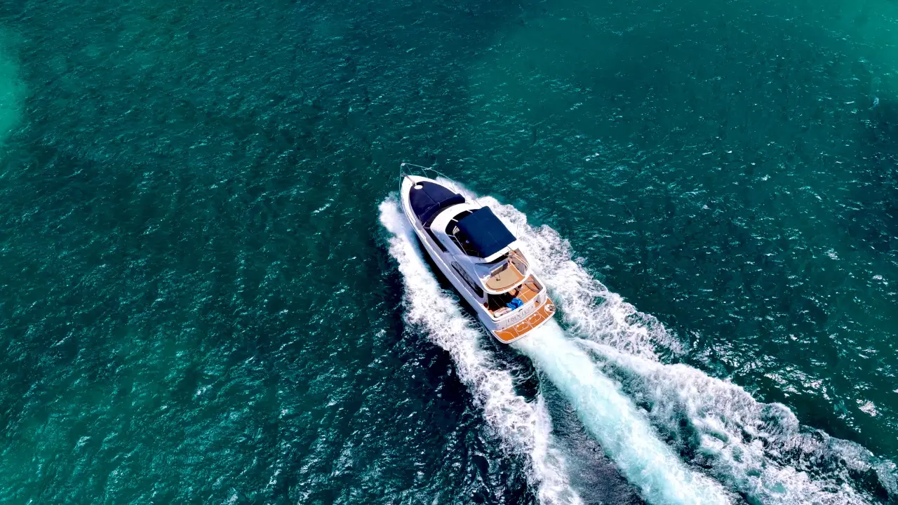 Drone view of Eden Luca Blue cruising with her navy bow lounge and teak aft deck