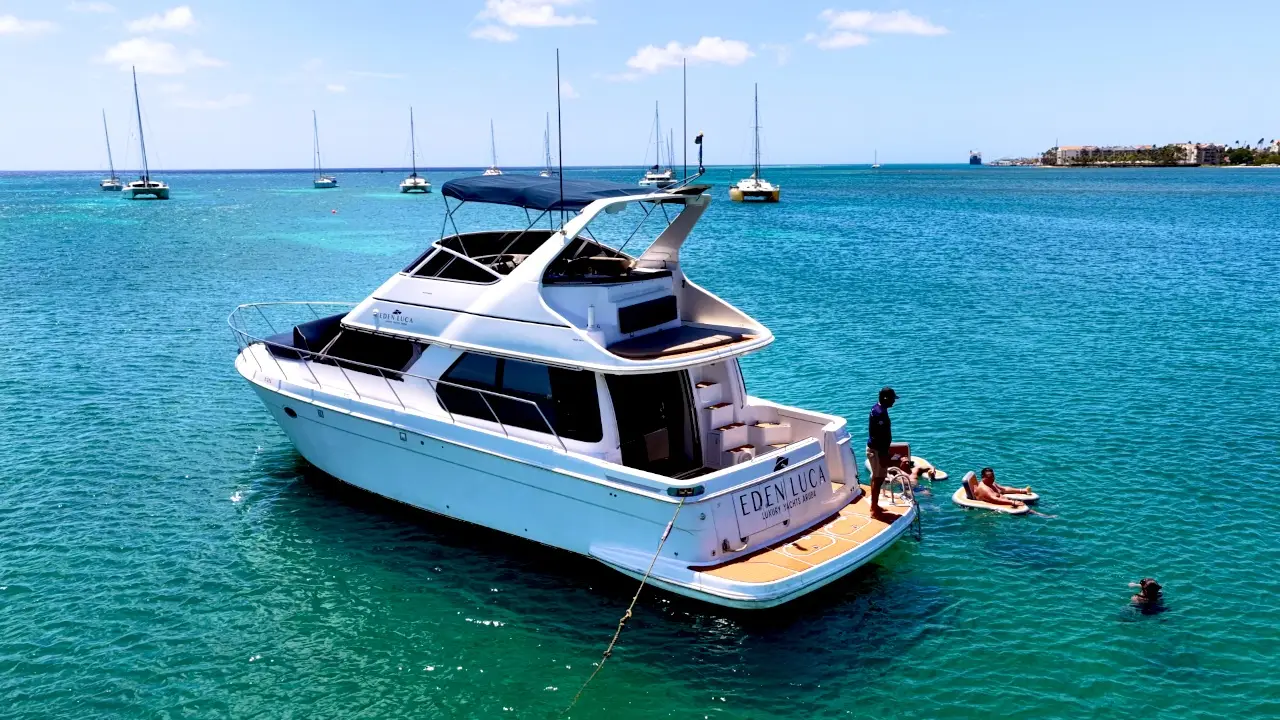 Eden Luca Blue's teak swim platform and the SunChill float in clear turquoise water